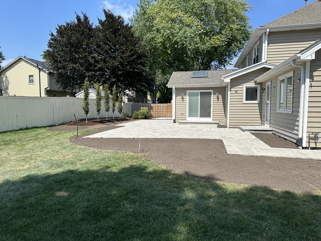 Multi-level Unilock paver patio with integrated fire pit in Will-O-Way, Naperville.